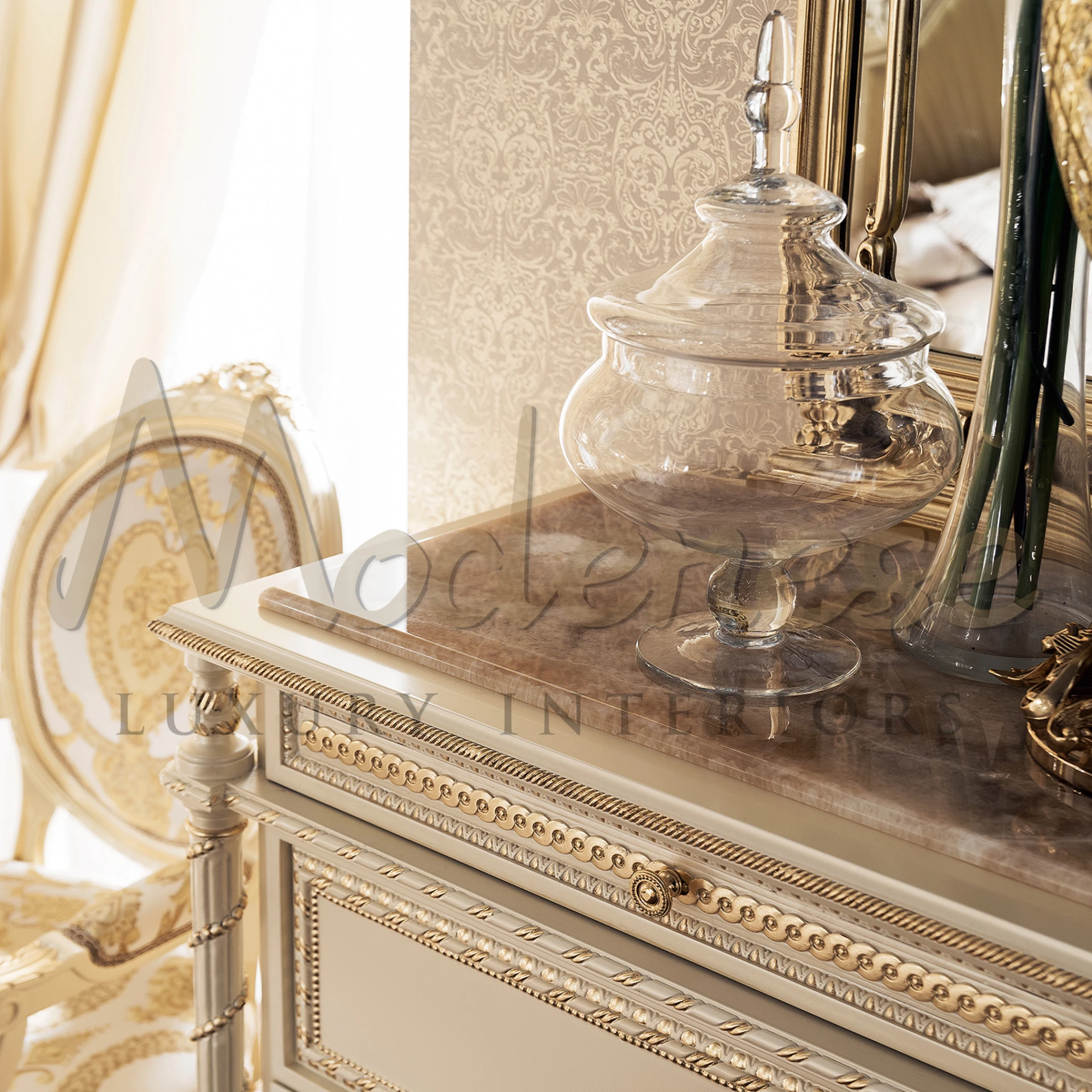 Sophisticated classical luxury ivory dresser with decorative carvings and a luxurious marble overlay made by Modenese Interiors Furniture Manufacturer in Italy