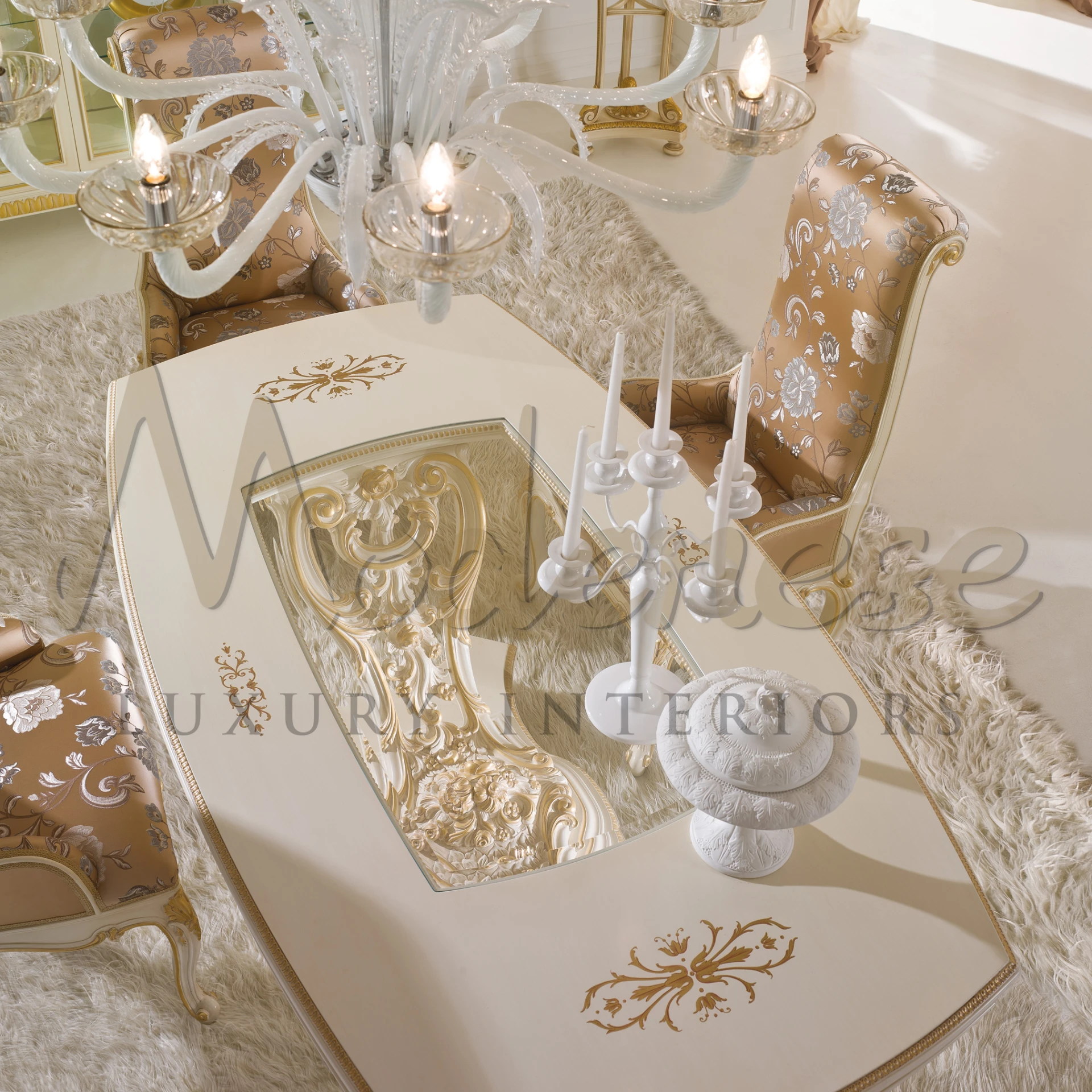 Luxurious dining room with a crystal chandelier and ornate furniture.