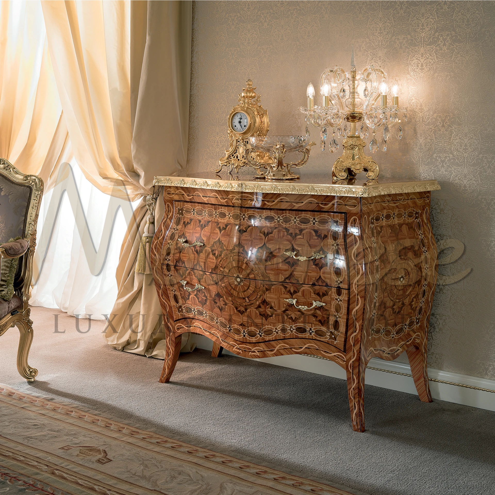 A shiny, hand carved wood cabinet with a golden clock and sparkly light fixture on it