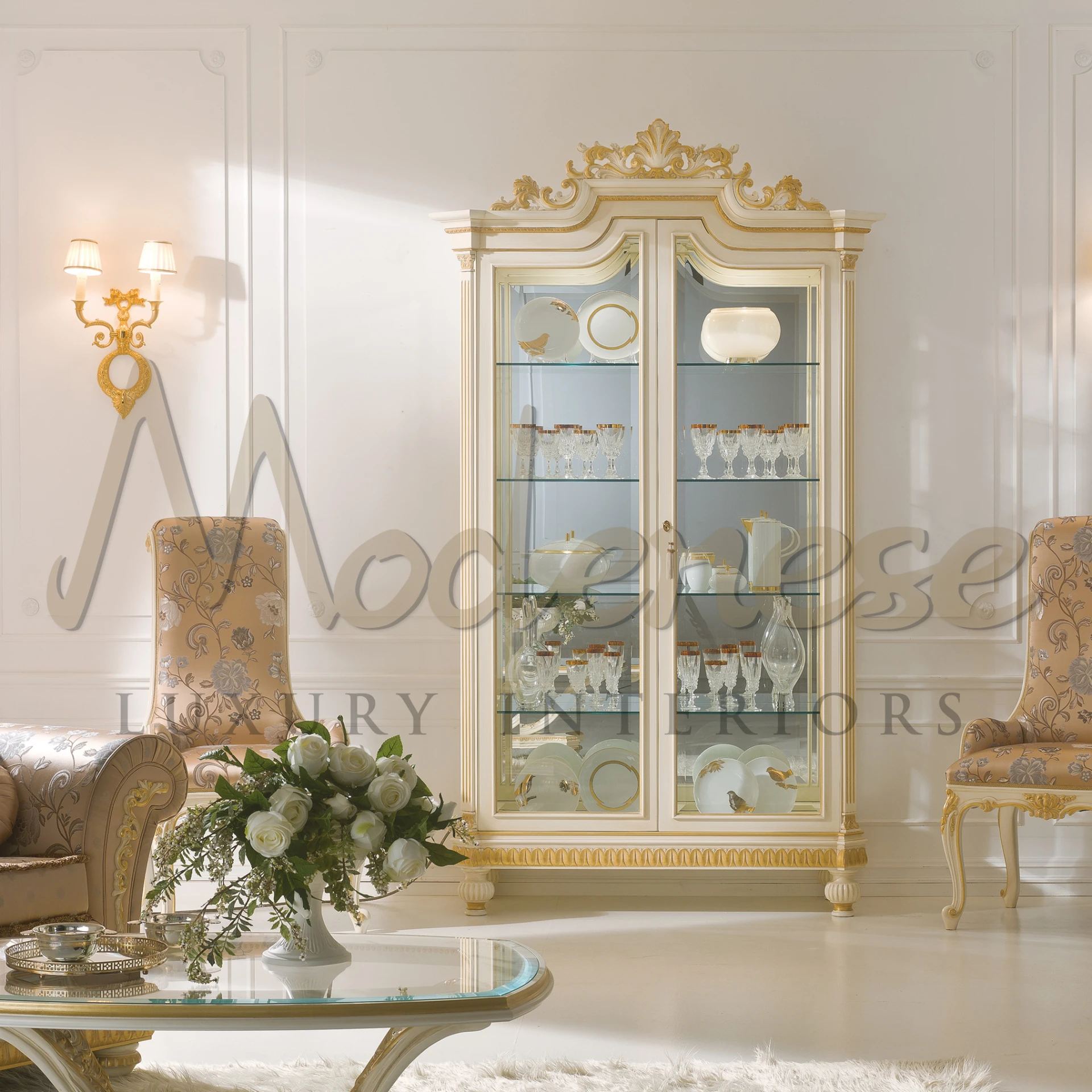 A decorated room with a cabinet with glass doors for dishes, a patterned chair, and a small table with a flower vase.