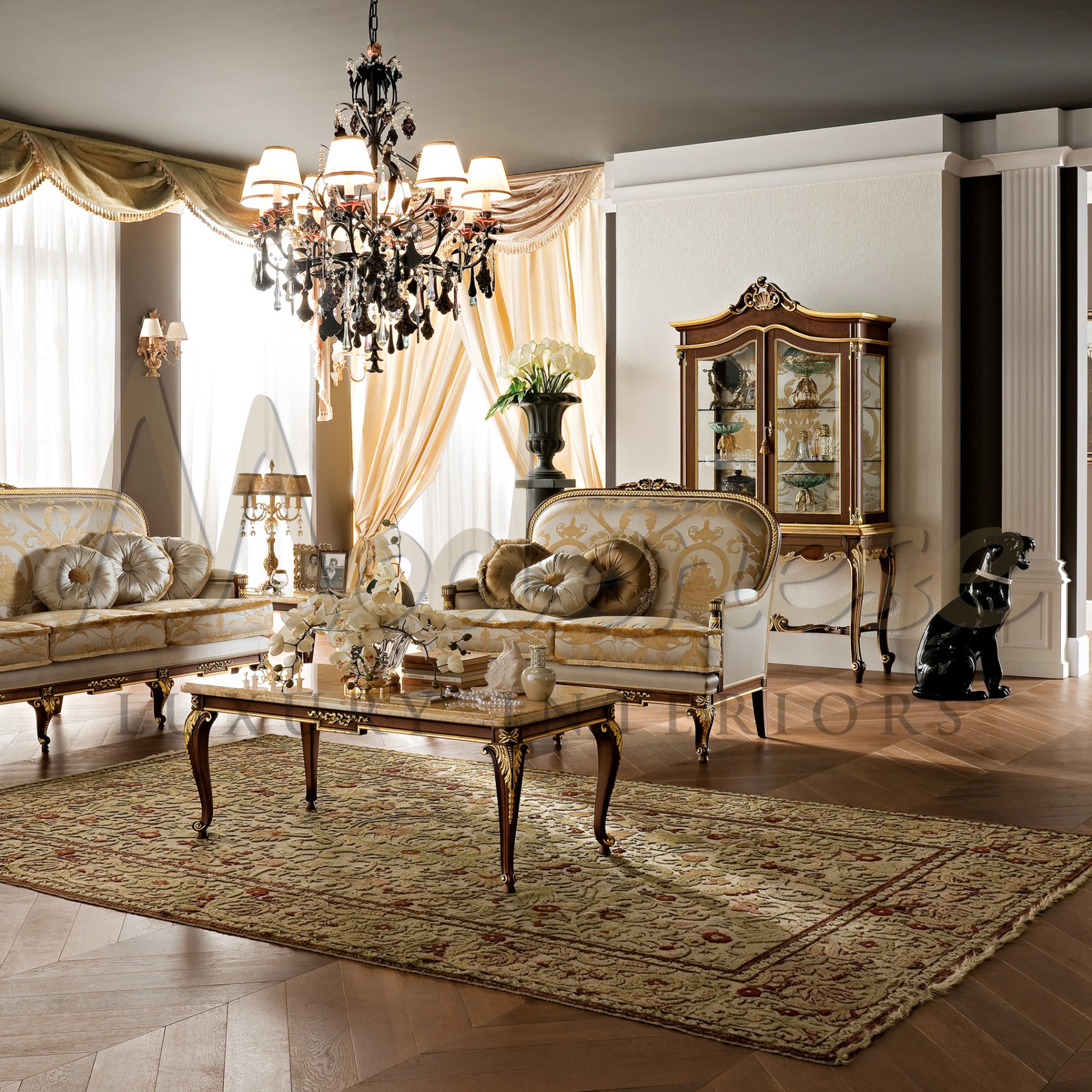 A luxury room with traditional decorations, a shiny chandelier, comfortable seating and imperial showcase secretaire.