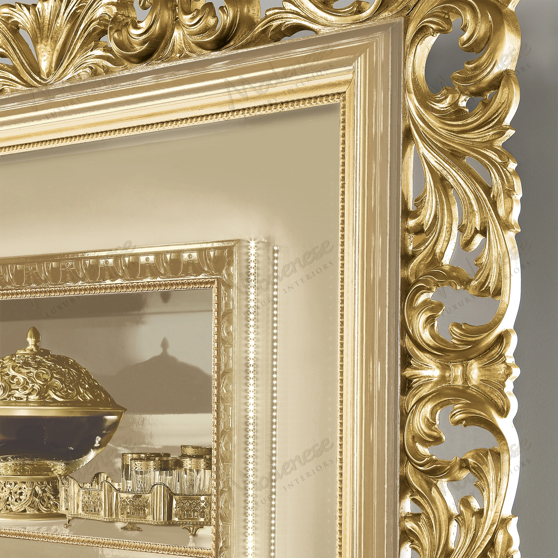 Handcrafted wooden bookshelf with a smooth ivory finish and intricate gold leaf accents