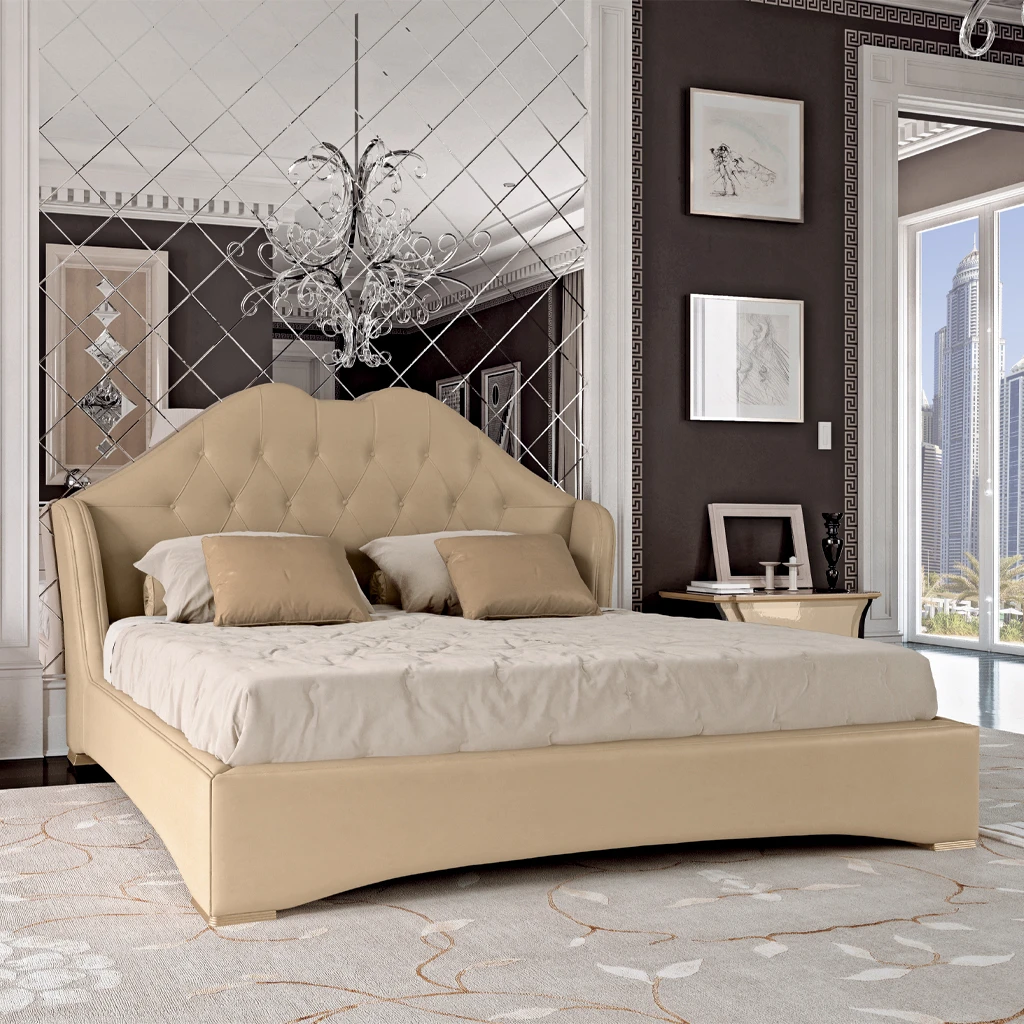 Close-up detail of the Prestige bed's upholstered headboard, highlighting its elegant classical curves and contrasting with the clean, contemporary lines of the bed frame.