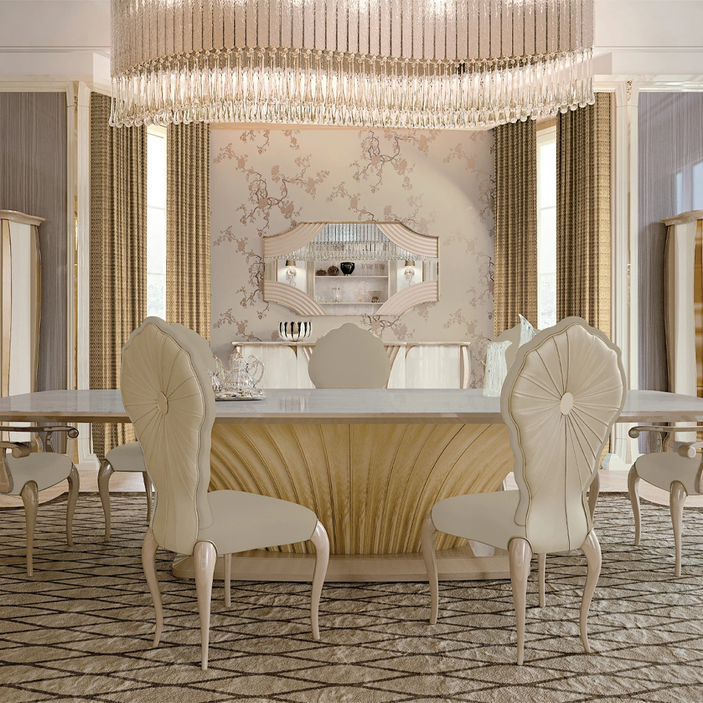 A luxurious eclectic dining room featuring a polished Makassar wood table contrasted with modern grey upholstered chairs under a sculptural crystal chandelier.