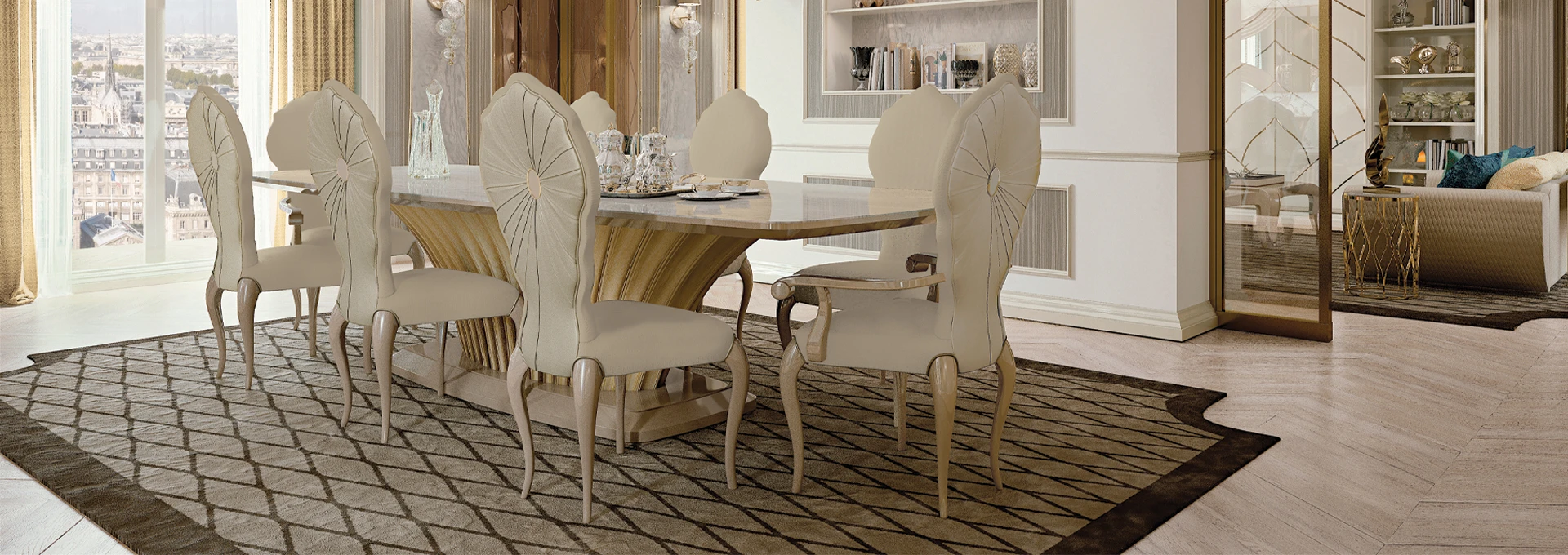 A luxurious eclectic dining room featuring a polished Makassar wood table contrasted with modern grey upholstered chairs under a sculptural crystal chandelier.