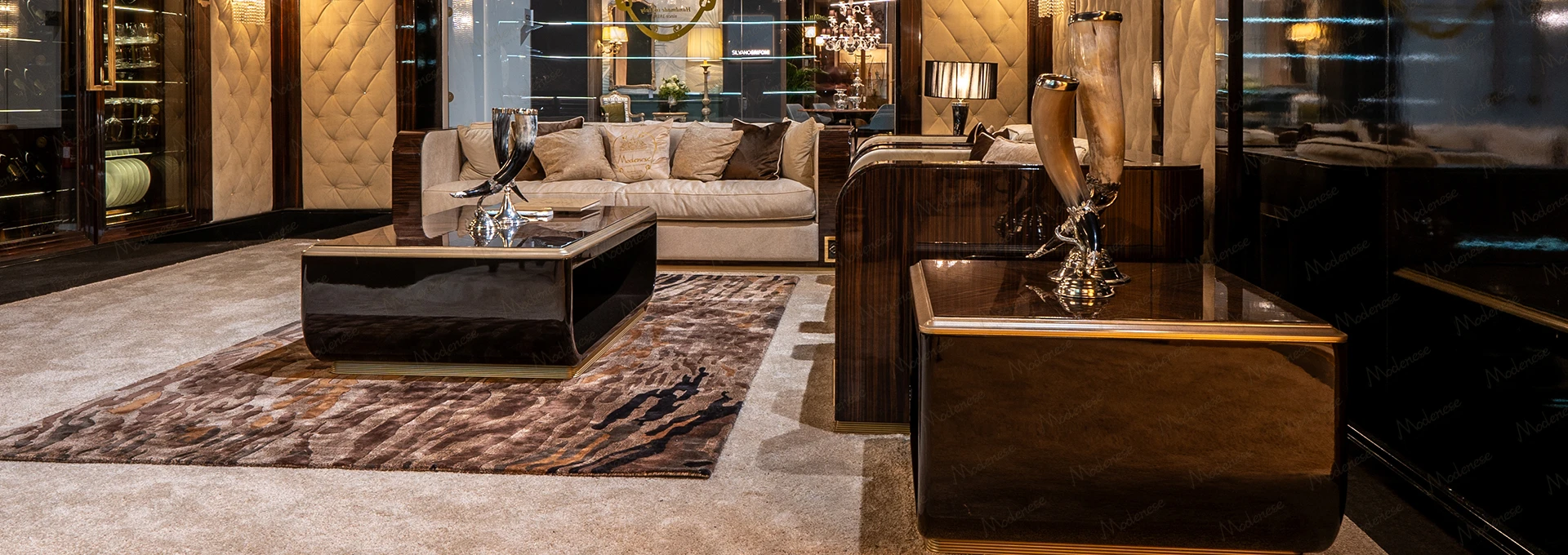 Detail shot of a contemporary armchair from the MODENESE PROJECT, showcasing its clean geometric lines and rich, dark upholstery, exemplifying modern Italian design.