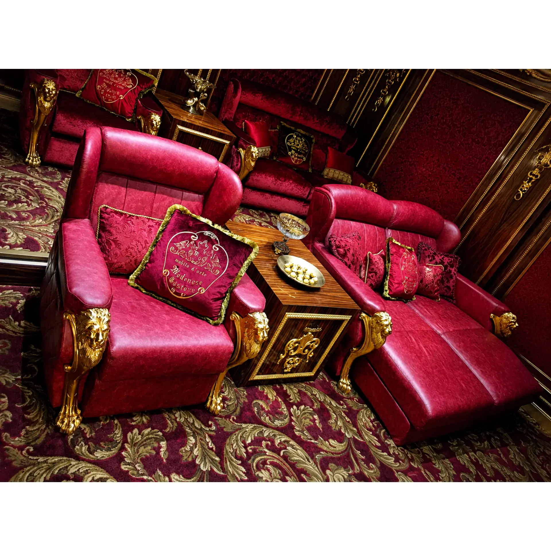 Luxury home cinema armchair with handcrafted carved wooden arms and premium upholstered seating.