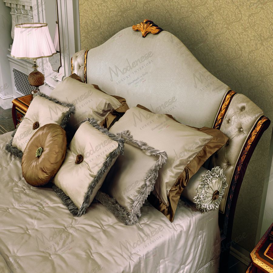 A member of the Modenese textile design team carefully selecting from a vibrant array of classical Sarelli Fabrics swatches for a custom pillow project.