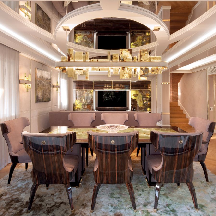 A sleek armchair from the FAOMA EVOLUTION new collection, showcasing the seamless joinery between a polished metal frame and rich, dark leather upholstery.