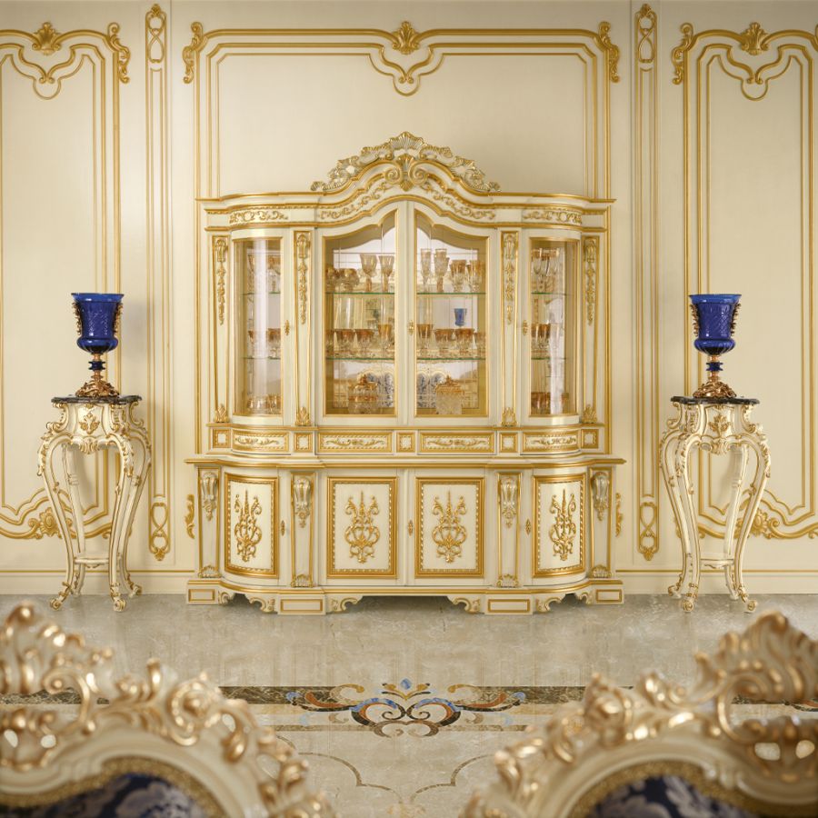 A sophisticated Heritage Dining room by Modenese Interiors, featuring an ornate gold and silver leaf table surrounded by classic chairs with vibrant, contemporary blue geometric fabric.