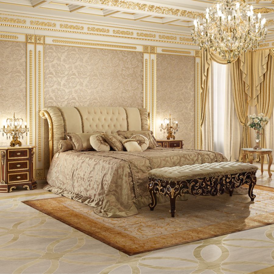 A sophisticated Heritage Bedroom featuring a grand, tufted headboard in powder pink velvet, flanked by ornate, hand-carved nightstands with gold leaf accents, defining classic bedroom design.