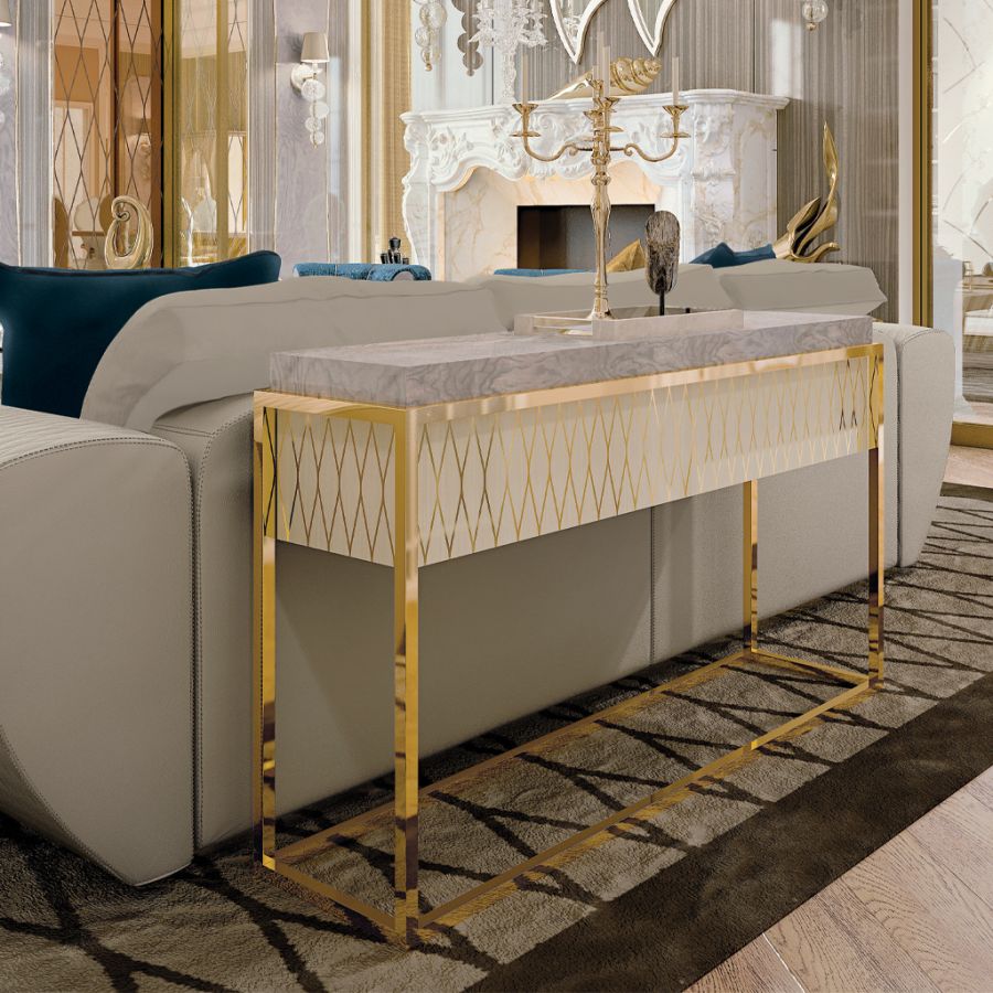 The harmonious contrast in an eclectic decor scheme, with a light-fabric armchair placed beside a dark, rich Makassar wood side table with brass details.