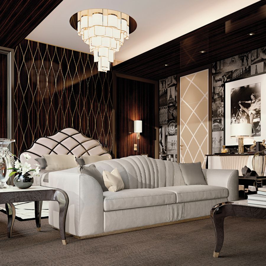 A modern eclectic bedroom illuminated by a sculptural gold pendant light, highlighting the seamless blend of textures and high-end bedroom design.