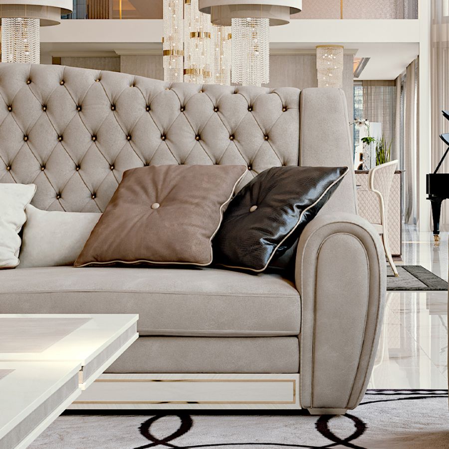 Detail of a luxury apartment interior by Modenese Projects, showing the textural contrast between a plush velvet sofa and a cool marble accent wall, exemplifying high-end design.
