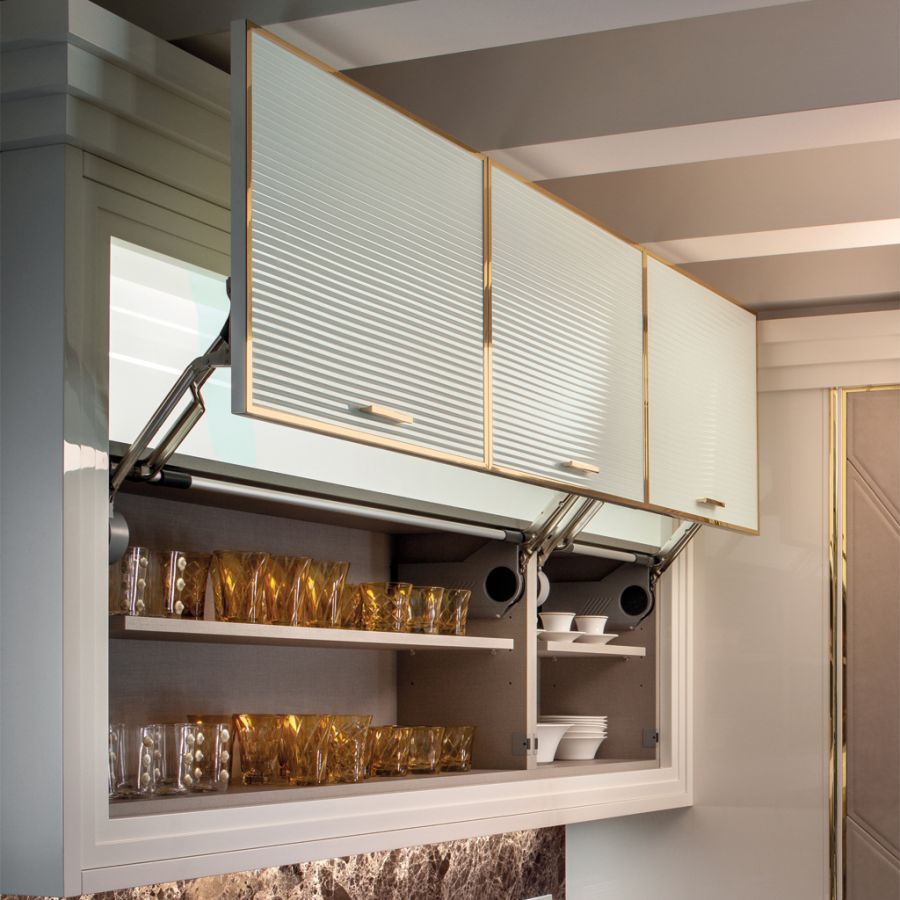 Detail shot of the bespoke Bottle Showcase, displaying prestigious champagne bottles like Dom P&eacute;rignon and Cristal within their custom niches.